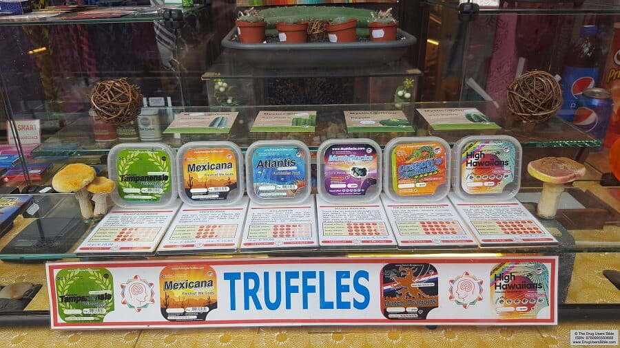 Commercial Display of Fresh Psilocybin Magic Truffles Varieties Store shelf showing packaged fresh magic truffles including Mexicana, Atlantis, and High Hawaiians strains in vacuum-sealed containers
